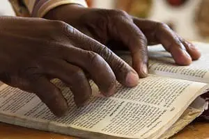 Marc-Ewell-African-hands-reading-Bible